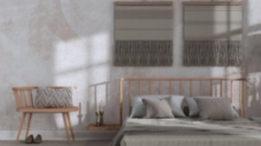 Blurred background, wabi sabi bedroom close up with macrame wall art and wallpaper. Wooden furniture, carpets and double bed. Japandi interior design