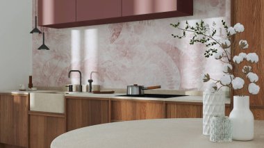 Japandi trendy wooden kitchen and dining room in white and red tones. Close up on table with cotton flowers, wallpaper, cabinets and marble top. Minimalist interior design