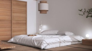Blurred background, japandi bedroom, japanese style. Double bed, tatami mats, paper lamp, meditation zen space. Minimalist interior design
