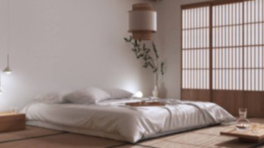 Blurred background, japanese bedroom, zen style. Double bed, tatami mats, meditation space. Minimalist japandi interior design