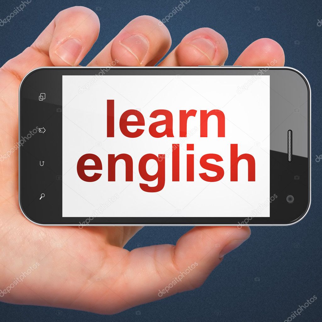 Hand holding smartphone with word learn english on display. Gene