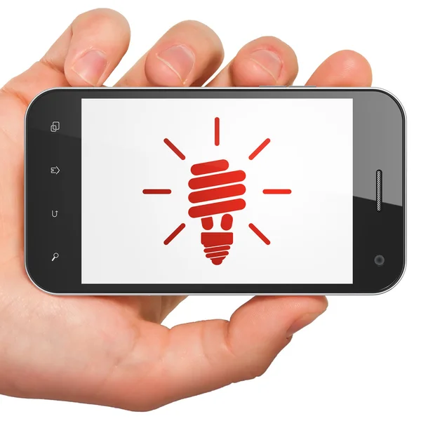 Фінансова концепція: енергозберігаюча лампа на смартфоні — стокове фото
