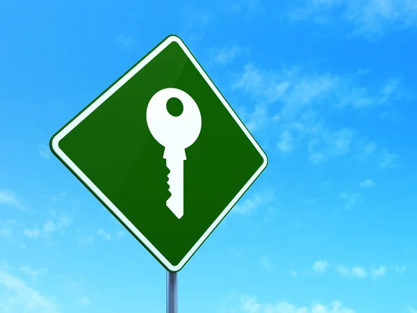 Security concept: Key on road sign background — Stock Photo, Image
