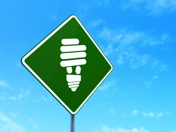 Business concept: Lampada a risparmio energetico su sfondo cartello stradale — Foto Stock