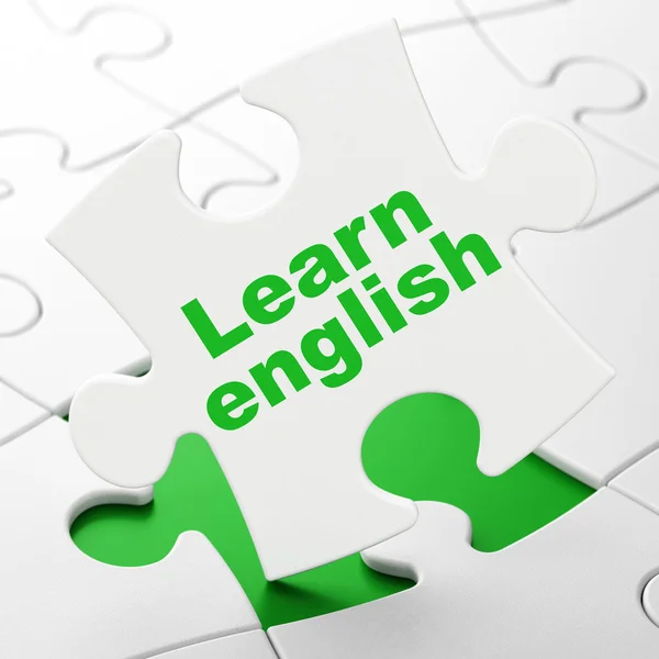 Концепция образования: Изучение английского языка на фоне головоломок — стоковое фото