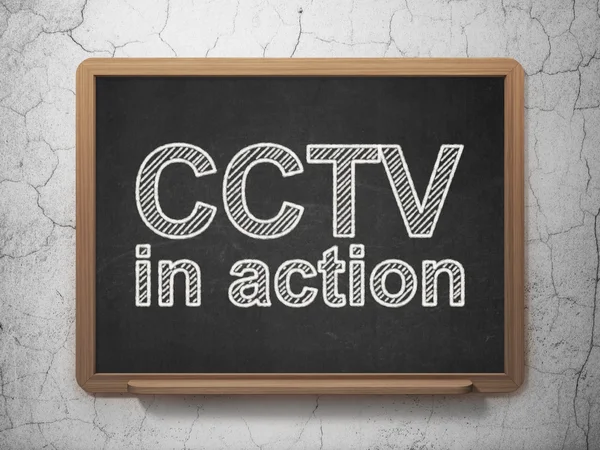 Conceito de privacidade: CCTV Em ação sobre fundo quadro-negro — Fotografia de Stock