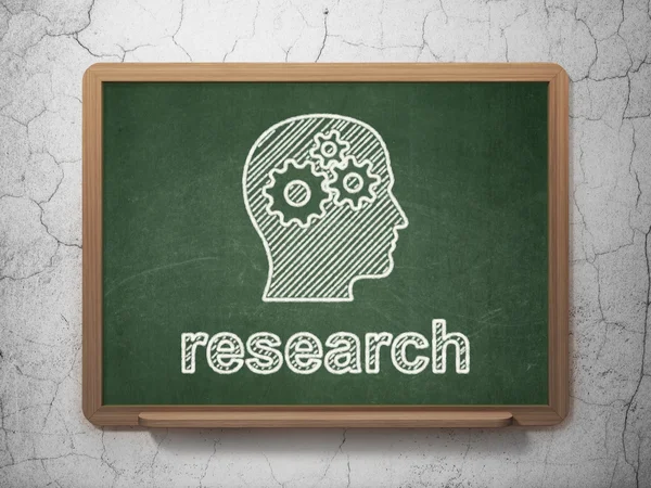 Marketing concept: Head With Gears and Research on chalkboard background