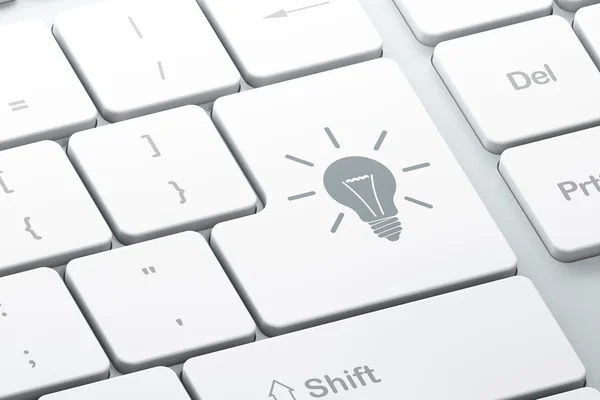 Finance concept: Light Bulb on computer keyboard background — Stock Photo, Image