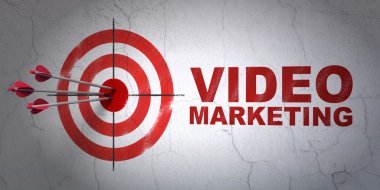 Business concept: target and Video Marketing on wall background clipart