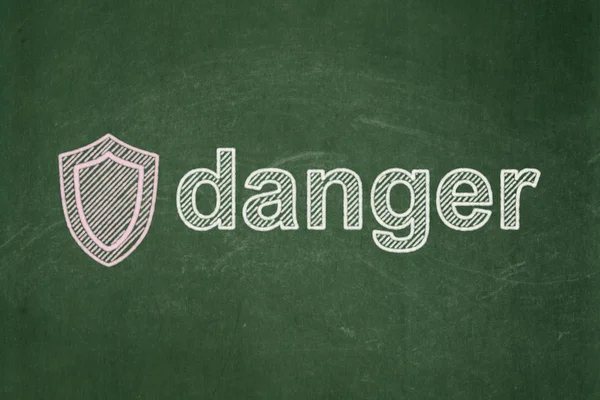 Protection concept: Shield and Danger on chalkboard background — Stock Photo, Image