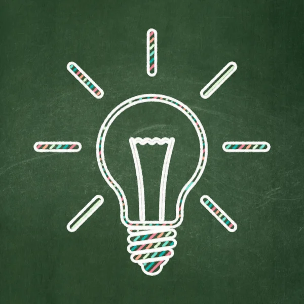 Finance concept: Light Bulb on chalkboard background — Stock Photo, Image