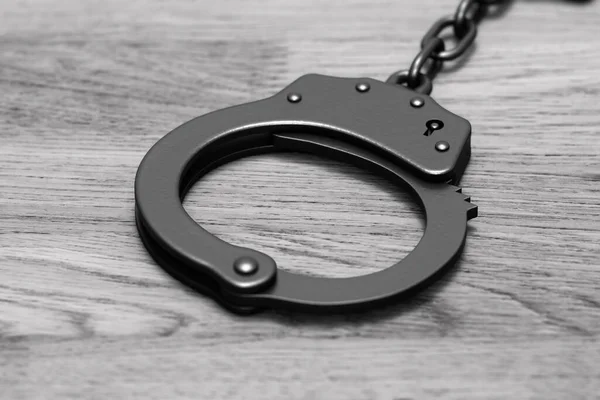 Grayscale 3D render: black locked police handcuffs — Stock Photo, Image