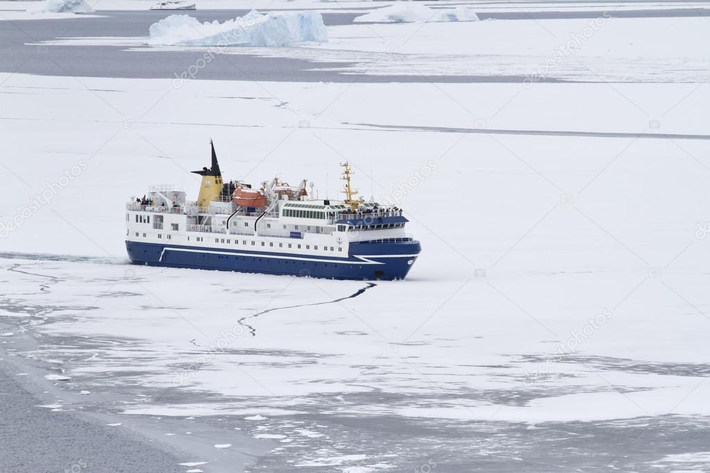 tourist ship breaking ice in the strait of the Antarctic Peninsu