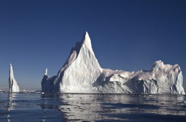 large iceberg with a few tops off the coast of Antarctica clipart