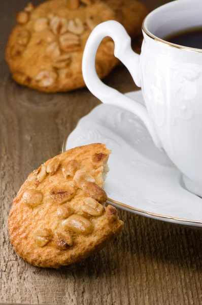 Nut cookies and white porcelain cup — Stock Photo, Image