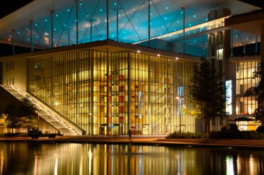 Stavros Niarchos Cultural Center in Athens, Greece at night with reflection in the water