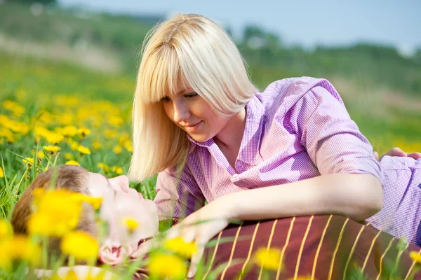 Girl with a guy on the field — Stock Photo, Image