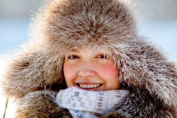 Happy young girl in a fur hat — Stock Photo, Image