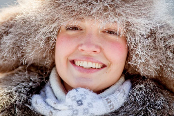 Happy young girl in a fur hat — Stock Photo, Image