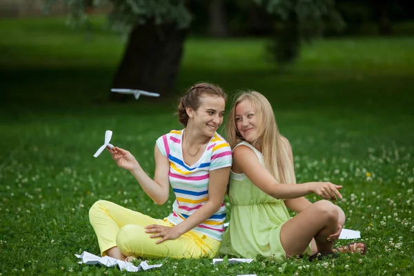 Девушки запускают бумажные самолеты — стоковое фото