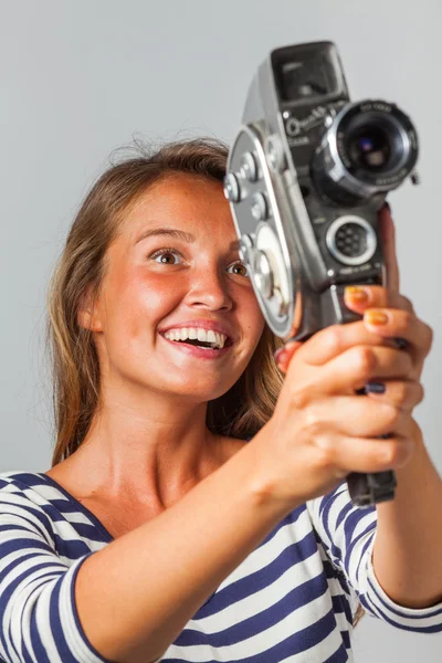 Girl with an 8mm retro movie camera — Stock Photo, Image