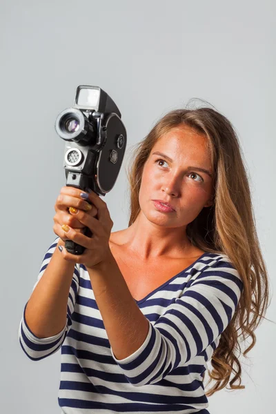 Girl with an 8mm retro movie camera — Stock Photo, Image