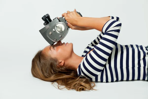 Girl with an 8mm retro movie camera — Stock Photo, Image