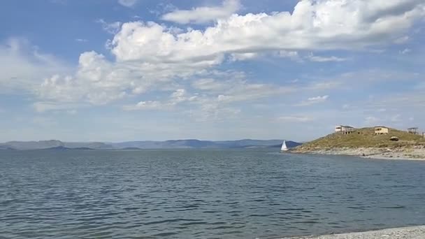 Clear Water Small Waves Mountains Distance Clouds Lake Yacht Moving — Stockvideo