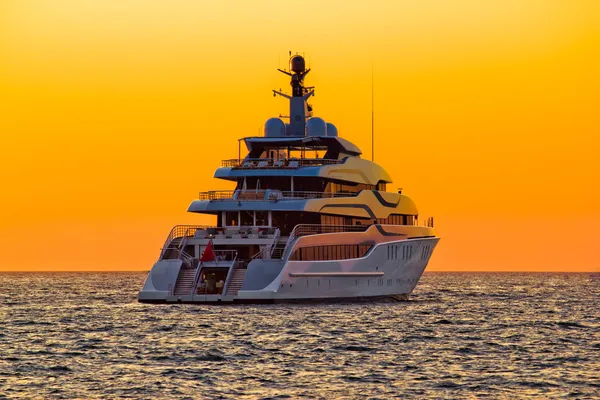 Luxury yacht on open sea at sunset — Stock Photo, Image