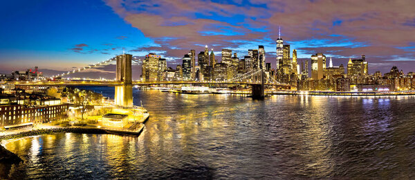 Epic skyline of New York City downtown and Brooklyn bridge evening view, United States of America