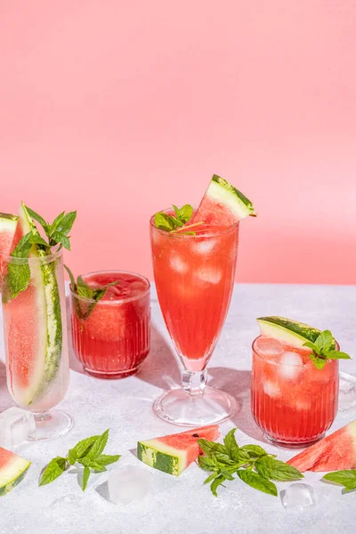 Different Elegant Glasses Watermelon Cocktail Splash Splatter Water Drops Pink — Stock Fotó
