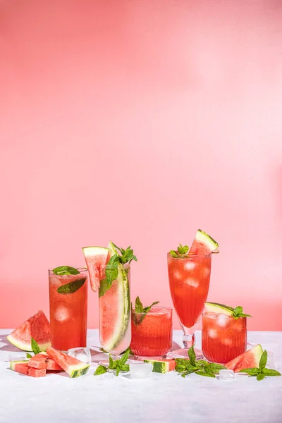 Different Elegant Glasses Watermelon Cocktail Splash Splatter Water Drops Pink — Stock Fotó