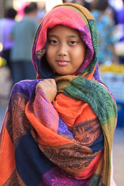 Girl and colorful silk clothes cover her head — Stock Photo, Image
