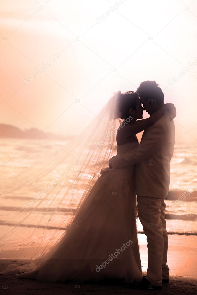 Bride and groom holding and hug at seaside