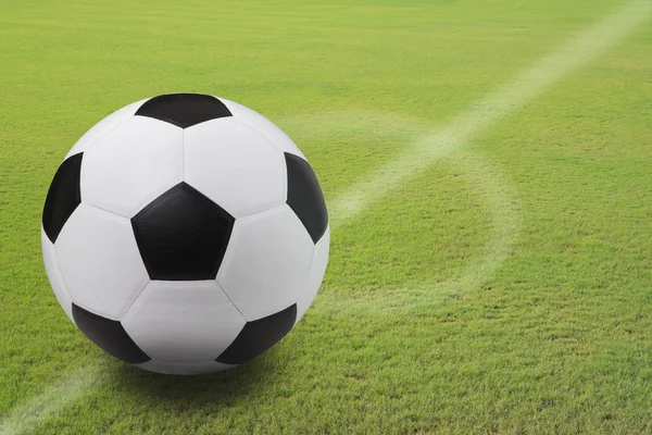 Soccer football on green grass field of stadium — Stock Photo, Image