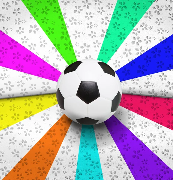Voetbal voetbal op kleurrijke ray achtergrond — Stockfoto