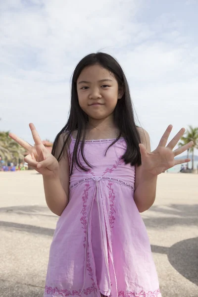 Asian girl show finger acting symbols — Stock Photo, Image