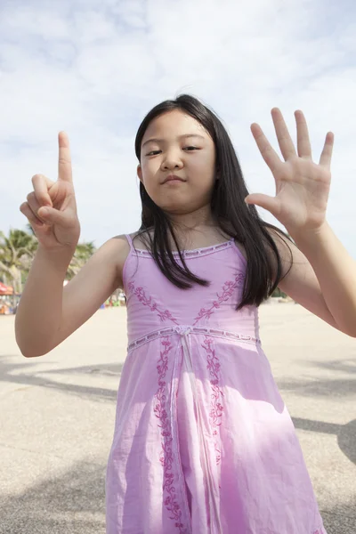 Asian girl show finger acting symbols — Stock Photo, Image