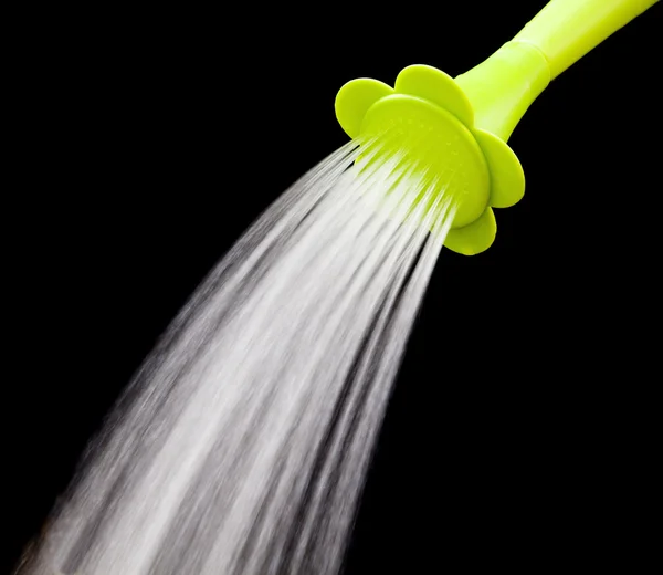 Green watering can pouring water with slow speed shutter isolate — Stock Photo, Image