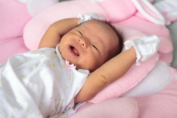 Infant sleep on the bed and smiling — Stock Photo, Image