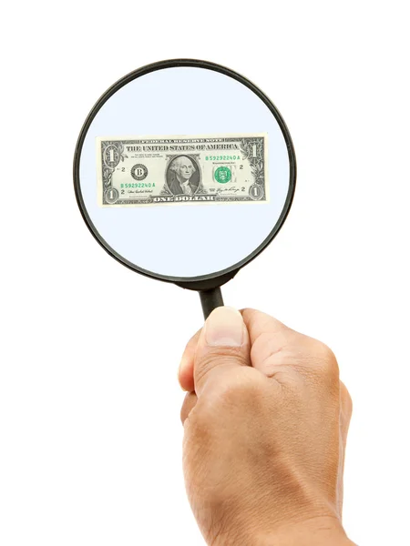 Dollar bill and hand holding magnifying glass — Stock Photo, Image