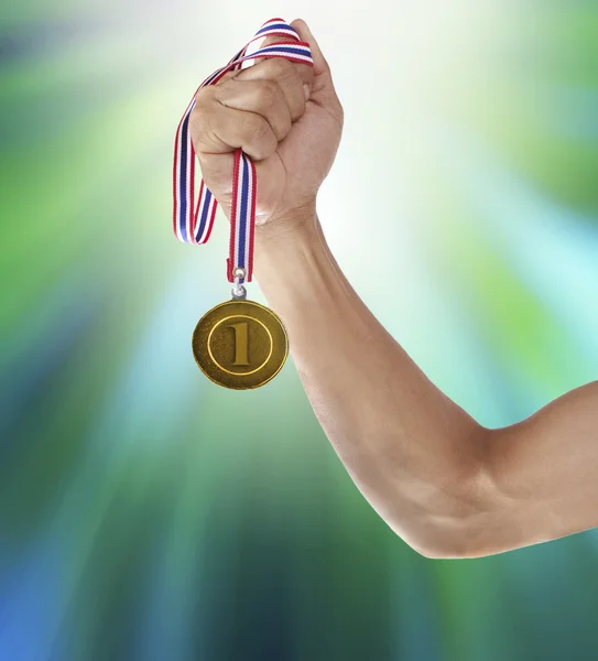 Hand and gold medal — Stock Photo, Image