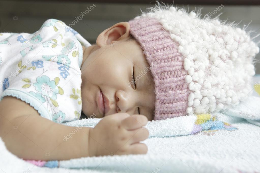 Face of baby asleeping on bed