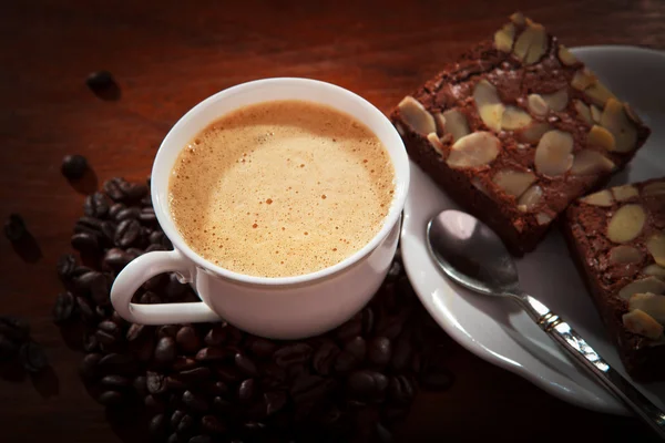 Hete koffie op brownie taart op houten tafel voor multifunctionele — Stockfoto