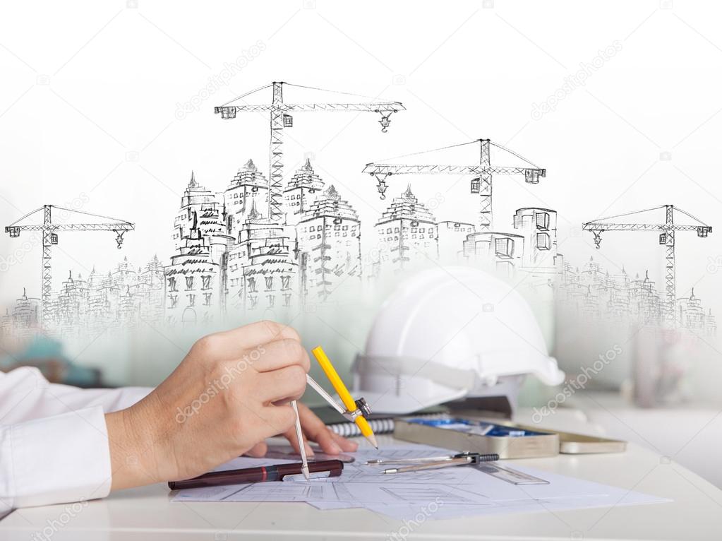 Architect working on talbe with sketching and building construct