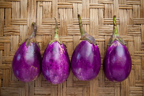 Purple eggplant on bamboo craft — Stock Photo, Image