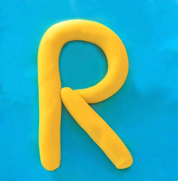 Yellow clay alphabet letter R — Stock Photo, Image