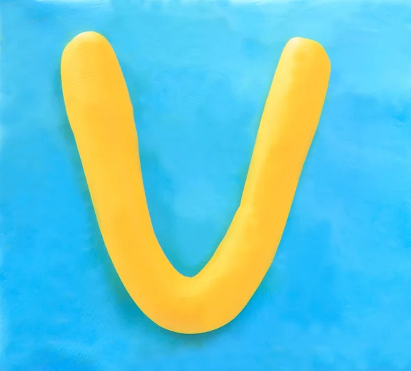 Yellow clay alphabet letter V — Stock Photo, Image