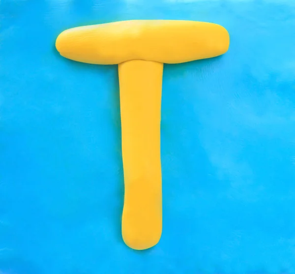 Yellow clay alphabet letter T — Stock Photo, Image