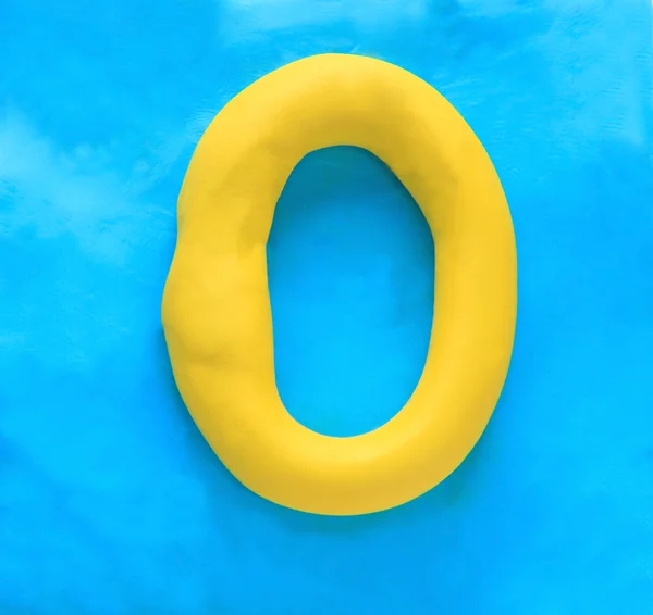 Yellow clay alphabet letter O — Stock fotografie